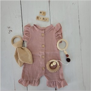 Muślinowy rampers niemowlęcy dla dziewczynki. Przewiewny dziewczęcy rampers z falbankami.  Rampers muślinowy w kolorze brudnego różu dla małej dziewczynki.