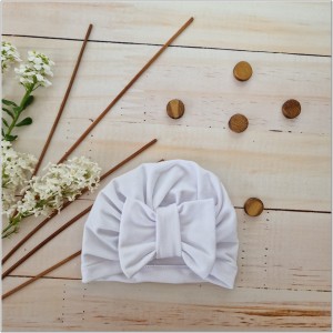 Cienka niemowlęca czapka prążkowana. Czapka z kokardą dla dziewczynki. Dresowa czapka z kokardą dla dziewczynki w kolorze białym.